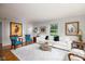Bright living room with a white sofa, blue armchairs, and a glass coffee table on top of a patterned rug at 2929 E 62Nd St, Indianapolis, IN 46220
