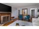Spacious living room featuring a stone fireplace, modern art, and plenty of natural light streaming through large windows at 2929 E 62Nd St, Indianapolis, IN 46220