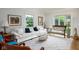 Living area filled with natural light, a large sofa, and decorative art that enhances the room's inviting atmosphere at 2929 E 62Nd St, Indianapolis, IN 46220