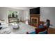 Elegant living space featuring a cozy fireplace, plush seating, and ample natural light, perfect for relaxing at 2929 E 62Nd St, Indianapolis, IN 46220