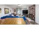 Cozy living room with comfortable blue sofa, brick fireplace, and natural light at 2929 E 62Nd St, Indianapolis, IN 46220