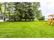 Lush backyard with large trees, green grass, play set, and a storage shed at 2965 E 1100 N, Pendleton, IN 46064