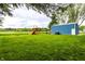 Spacious backyard with lush green grass and a blue shed near a playset at 2965 E 1100 N, Pendleton, IN 46064