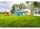 Expansive backyard with a playset and a shed surrounded by green lawn at 2965 E 1100 N, Pendleton, IN 46064