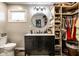 Modern bathroom vanity, round mirror, and open closet shelving provide storage and style at 2965 E 1100 N, Pendleton, IN 46064