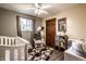 Charming Bedroom with a wooden accent wall, crib, and stylish decor at 2965 E 1100 N, Pendleton, IN 46064