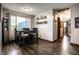 Bright dining room features a window view, modern wood floors, and stylish shelving with decor at 2965 E 1100 N, Pendleton, IN 46064