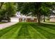 Charming brick home featuring an attached garage, lush lawn and mature shade tree at 2965 E 1100 N, Pendleton, IN 46064