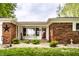 Charming brick home with a well-manicured front yard, tasteful decor and a red front door at 2965 E 1100 N, Pendleton, IN 46064
