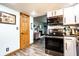 Efficient kitchen featuring white cabinets and stainless appliances; opens to living area at 2965 E 1100 N, Pendleton, IN 46064