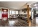 Open-concept living room with dark floors, cozy furnishings and a seamless flow into the kitchen at 2965 E 1100 N, Pendleton, IN 46064