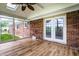Bright sun room with wood floors, exposed brick and large windows offering natural light at 2965 E 1100 N, Pendleton, IN 46064