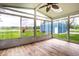 Inviting sun room with hardwood floors offering views of the backyard and play set at 2965 E 1100 N, Pendleton, IN 46064