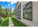 A stone walkway leads to a screened in back porch with backyard and tasteful plantings at 3033 Daum Ct, Carmel, IN 46033