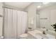 Bright bathroom featuring a white vanity, toilet, shower with curtain and a large mirror at 3033 Daum Ct, Carmel, IN 46033