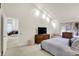 Well-lit bedroom with neutral tones, a comfortable bed, and scenic views through the windows at 3033 Daum Ct, Carmel, IN 46033