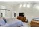 Spacious bedroom featuring a comfortable bed, storage furniture, and ambient lighting at 3033 Daum Ct, Carmel, IN 46033