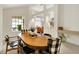 Bright dining room featuring a wooden table with stylish chairs and large windows for a modern, inviting atmosphere at 3033 Daum Ct, Carmel, IN 46033