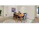 Bright dining room featuring a wooden table with stylish chairs and large windows for a modern, inviting atmosphere at 3033 Daum Ct, Carmel, IN 46033