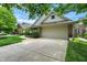 View of the two-car garage and wide driveway of a single-Gathering home in a suburban neighborhood at 3033 Daum Ct, Carmel, IN 46033
