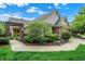 View of the front yard and entrance of a single Gathering home with mature trees and lush landscaping at 3033 Daum Ct, Carmel, IN 46033