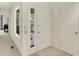 Bright hallway featuring neutral walls and carpet, with views of the front door and exterior at 3033 Daum Ct, Carmel, IN 46033