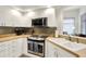 Bright kitchen with white cabinetry, stainless steel appliances, and modern backsplash for a clean and inviting space at 3033 Daum Ct, Carmel, IN 46033