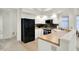Modern kitchen featuring white cabinets, black appliances, and butcher block countertops, offering style and functionality at 3033 Daum Ct, Carmel, IN 46033