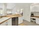 Bright kitchen with stainless steel dishwasher, wood countertops, and breakfast bar area to living room at 3033 Daum Ct, Carmel, IN 46033