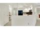 A partial view of the kitchen, showing white cabinets and black appliances through an opening in the wall at 3033 Daum Ct, Carmel, IN 46033