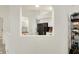 A view into the kitchen with white cabinetry and black appliances, as seen through a unique architectural opening at 3033 Daum Ct, Carmel, IN 46033