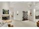 Bright living room featuring a fireplace, sleek shelving, and neutral carpet for a modern, inviting atmosphere at 3033 Daum Ct, Carmel, IN 46033