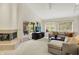 Comfortable living room with fireplace, multiple windows, and access to covered porch at 3033 Daum Ct, Carmel, IN 46033