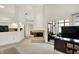 Open living room with modern fireplace and patio access, next to a kitchen area at 3033 Daum Ct, Carmel, IN 46033