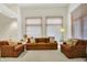 Bright living room with vaulted ceilings, neutral colors, large windows, and comfortable seating at 3033 Daum Ct, Carmel, IN 46033