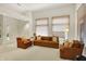 Bright living room with vaulted ceilings, neutral colors, large windows, and comfortable seating at 3033 Daum Ct, Carmel, IN 46033