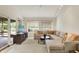 Open-concept living room includes access to a patio, large sectional sofa, and ample lighting at 3033 Daum Ct, Carmel, IN 46033