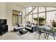 Relaxing covered porch with seating, dining, outdoor lighting, and pleasant backyard views at 3033 Daum Ct, Carmel, IN 46033