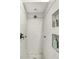 This shower features white marble tile and dark bronze fixtures, plus tiled insets for storage at 3033 Daum Ct, Carmel, IN 46033