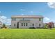 Large backyard with a well-maintained lawn, featuring a two-story house and thoughtfully designed landscaping at 3267 Cimmaron Ash Ct, Zionsville, IN 46077