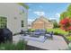 Outdoor patio features comfortable seating, and a view of the backyard, home, and mature trees at 3267 Cimmaron Ash Ct, Zionsville, IN 46077