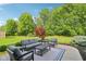 Outdoor patio with comfortable seating, a rug, and mature trees in the background at 3267 Cimmaron Ash Ct, Zionsville, IN 46077