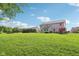 Expansive backyard featuring a lush lawn, mature trees, and a charming two-story home with a patio area at 3267 Cimmaron Ash Ct, Zionsville, IN 46077
