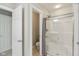 Bright bathroom featuring a glass shower with shower curtain, neutral walls, and an attached toilet room at 3267 Cimmaron Ash Ct, Zionsville, IN 46077