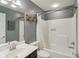Full bathroom features a shower and tub combination with white fixtures, vanity, and medicine cabinet at 3267 Cimmaron Ash Ct, Zionsville, IN 46077