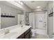 Modern bathroom with double sink vanity, framed mirrors, a shower-tub combination, and tiled floors at 3267 Cimmaron Ash Ct, Zionsville, IN 46077
