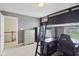 Bedroom features carpet, neutral walls, and a sleek black loft bed with a desk area, maximizing space at 3267 Cimmaron Ash Ct, Zionsville, IN 46077
