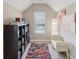 Cozy nook with bookshelf and colorful rug, illuminated by natural light filtering through the window at 3267 Cimmaron Ash Ct, Zionsville, IN 46077