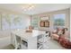 Bright bonus room with large crafting table, comfortable seating, and plenty of natural light at 3267 Cimmaron Ash Ct, Zionsville, IN 46077
