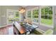 Bright dining area with hardwood floors, pendant lighting, and views of the outdoor space at 3267 Cimmaron Ash Ct, Zionsville, IN 46077
